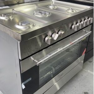 NEW EURO EV900DPSX 900MM DUAL FUEL FREESTANDING OVEN WITH 5 GAS BURNER COOKTOP WITH CENTRAL WOK WITH ELECTRIC 8 MULTI FUNCTION OVEN DIGITAL PROGRAM CLOCK TRIPLE GLAZED OVEN DOOR CLOSED DOOR GRILLING ROTISSERIE WITH LOWER STORAGE COMPARTMENT 2 YEAR WARRANTY **DENTED SOLD A