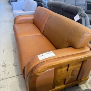NEW TAN LEATHER OVERSIZE 2 SEATER COUCH, WITH ORNATE TIMBER FRAME, SOME DENTS, SOLD AS IS