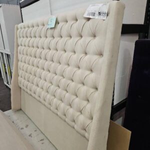 EX STAGING FURNITURE - QUEEN UPHOLSTERED CREAM BEDHEAD, SOLD AS IS