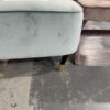 EX STAGING - GREEN VELVET CHAIR, SLIGHTLY BENT FRONT LEG, SOLD AS IS