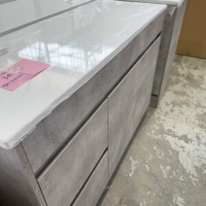 NEW LOLA 1200MM CONCRETE LOOK FLOOR VANITY, FINGER PULL LEFT HAND DRAWER, WITH FLAT WHITE STONE TOP WITH NO HOLE CA11-1200L-ST56FT