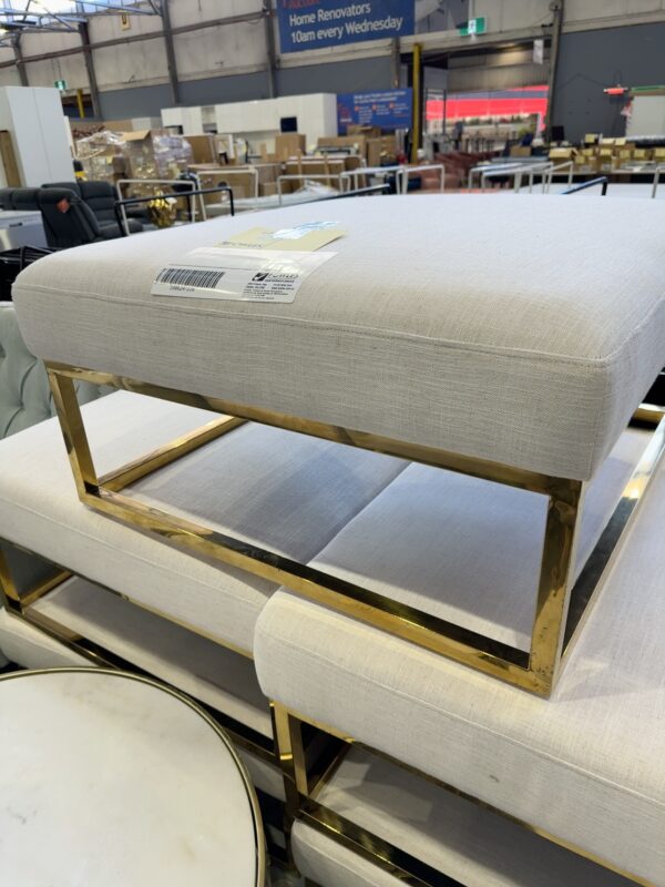 EX STAGING FURNITURE - GOLD METAL & CREAM UPHOLSTERD OTTOMAN,SOLD AS IS
