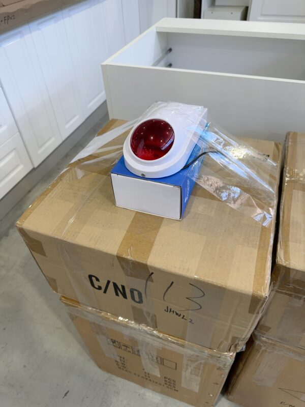 BOX OF RED WIRED OUTDOOR SIREN WITH 12 VOLT CHARGERS, QTY 40 SIRENS & 36 12VOLT CHARGERS SOLD AS IS, NO WARRANTY